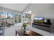 Airy living room featuring a vaulted ceiling, large windows, and a view of the outdoor scenery at 5531 S Telluride Ct, Centennial, CO 80015