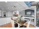 Open-concept area with dining table, kitchen, and access to a bright sun room and outside views at 5531 S Telluride Ct, Centennial, CO 80015