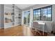 Bright home office with built-in shelves, a large window, and a sliding door to a balcony at 5531 S Telluride Ct, Centennial, CO 80015