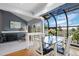 Bright dining area sunroom with a brick fireplace, lots of glass, and outdoor views at 5531 S Telluride Ct, Centennial, CO 80015