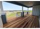 Wide balcony with wood floors and railing, providing stunning views of the surrounding landscape at 8326 Cokedale Cir, Littleton, CO 80125