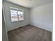 Bright bedroom with neutral carpet and a large window letting in natural light at 8326 Cokedale Cir, Littleton, CO 80125