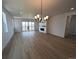 Spacious living room boasting a modern chandelier, fireplace, and sliding glass doors to a balcony at 8326 Cokedale Cir, Littleton, CO 80125