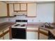 Functional kitchen featuring white cabinets and standard appliances at 4760 S Wadsworth # 301, Littleton, CO 80123