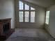 Spacious living room with high windows and a classic brick fireplace at 4760 S Wadsworth # 301, Littleton, CO 80123