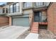 Inviting front entrance of townhome featuring steps to the front door and a garage at 7450 W Coal Mine Ave # D, Littleton, CO 80123
