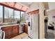 Spacious kitchen with stainless steel refrigerator, large window, and custom cabinets, creating an inviting space at 7450 W Coal Mine Ave # D, Littleton, CO 80123