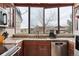 This kitchen features a large window, stainless steel appliances, and stone countertops, offering natural light at 7450 W Coal Mine Ave # D, Littleton, CO 80123