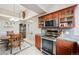Charming kitchen with stainless steel appliances, including microwave and range, along with a view into the dining area at 7450 W Coal Mine Ave # D, Littleton, CO 80123