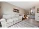 Inviting living room with neutral tones, wood floors, and a comfortable sofa; entrance to second floor at 7450 W Coal Mine Ave # D, Littleton, CO 80123