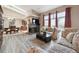 Bright living room with a fireplace, large windows, and access to the dining area at 7450 W Coal Mine Ave # D, Littleton, CO 80123