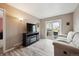 Bright living room with sliding glass doors to deck, television, and light-colored wood floors at 7450 W Coal Mine Ave # D, Littleton, CO 80123