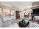 Spacious living room showing hardwood flooring, staircase, and access to dining area at 7450 W Coal Mine Ave # D, Littleton, CO 80123