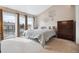 Bright main bedroom with large windows, comfortable bed, carpeted floors, and stylish decor at 7450 W Coal Mine Ave # D, Littleton, CO 80123