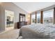 Spacious main bedroom with connecting bathroom, large windows offering neighborhood views, and ample natural light at 7450 W Coal Mine Ave # D, Littleton, CO 80123