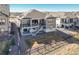 Aerial view of a two-story home with a backyard, outdoor stairs, and a stone and gravel backyard at 8784 S Riviera Ct, Aurora, CO 80016
