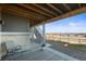 Back patio with gray furniture, an outdoor stair case, and a view of the surrounding neighborhood at 8784 S Riviera Ct, Aurora, CO 80016
