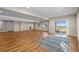 Spacious finished basement with wood-look floors, and natural light from the sliding glass door at 8784 S Riviera Ct, Aurora, CO 80016