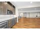 Finished basement bar area with stainless steel appliances, sink, and custom cabinetry at 8784 S Riviera Ct, Aurora, CO 80016