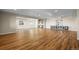 Open basement with wood-look floors, recessed lighting, and natural light from the windows at 8784 S Riviera Ct, Aurora, CO 80016