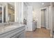Modern bathroom featuring a gray vanity, stone countertop, and an open doorway to a shower at 8784 S Riviera Ct, Aurora, CO 80016