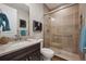 Modern bathroom featuring dark wood vanity and glass door shower with tiled walls at 8784 S Riviera Ct, Aurora, CO 80016