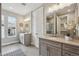Bright bathroom featuring double vanity, neutral decor, and a view of the exterior at 8784 S Riviera Ct, Aurora, CO 80016