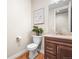 Cozy bathroom features modern vanity, sink, toilet, and sleek fixtures on wood-look floor at 8784 S Riviera Ct, Aurora, CO 80016