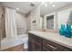 Bathroom with tub-shower combo, gray vanity, and blue decorative bottles at 8784 S Riviera Ct, Aurora, CO 80016