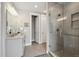 Bathroom featuring large frameless glass shower and double doors to a large closet at 8784 S Riviera Ct, Aurora, CO 80016