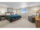 Finished bedroom with a bed, side tables, and a window with a view, carpet flooring at 8784 S Riviera Ct, Aurora, CO 80016