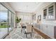 Elegant dining room with modern chandelier, neutral paint, and large windows at 8784 S Riviera Ct, Aurora, CO 80016
