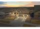 A beautiful home with a 3 car garage and professional landscaping, photographed at sunset at 8784 S Riviera Ct, Aurora, CO 80016