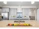 Modern kitchen featuring gray cabinets, stainless steel appliances, and a spacious center island with a sink at 8784 S Riviera Ct, Aurora, CO 80016