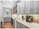 Well-organized kitchen with ample gray cabinetry, countertop space, and a built-in desk area at 8784 S Riviera Ct, Aurora, CO 80016