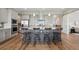 Modern kitchen island with stainless steel appliances and seating at 8784 S Riviera Ct, Aurora, CO 80016