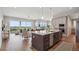 Open concept kitchen with island, stainless appliances, and hardwood floors overlooking the living space at 8784 S Riviera Ct, Aurora, CO 80016