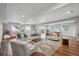Spacious living room with wood floors, neutral decor, and ample natural light at 8784 S Riviera Ct, Aurora, CO 80016