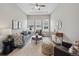 Bright living room with a plush sofa, high ceilings, and lots of natural light at 8784 S Riviera Ct, Aurora, CO 80016