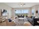 Bright living room with modern furniture, large windows, and scenic outdoor views at 8784 S Riviera Ct, Aurora, CO 80016