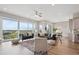 Open-concept living room with modern furniture, recessed lights, and large windows at 8784 S Riviera Ct, Aurora, CO 80016