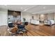 Open-concept living room with dining area and bar, great for entertaining and gatherings at 8784 S Riviera Ct, Aurora, CO 80016