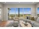 A lovely living room features a large window overlooking the surrounding community at 8784 S Riviera Ct, Aurora, CO 80016