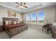 Serene main bedroom featuring a tray ceiling, ample natural light, and a comfortable seating area at 8784 S Riviera Ct, Aurora, CO 80016
