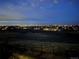An amazing night view of illuminated cityscape with a community of houses at dusk at 8784 S Riviera Ct, Aurora, CO 80016