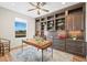 A stylish home office features a ceiling fan, window and built-in wood shelving at 8784 S Riviera Ct, Aurora, CO 80016