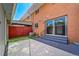 Backyard features brick exterior, patio, slider, and artificial grass at 3806 S Yosemite St, Denver, CO 80237