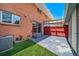 Backyard brick exterior with grass turf, patio and sliding glass door at 3806 S Yosemite St, Denver, CO 80237