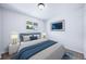 This bedroom boasts a bed, bedside lamps, and a framed art piece on the wall at 3806 S Yosemite St, Denver, CO 80237