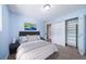 This is a cozy bedroom with a queen-sized bed, closet, and a modern gray decor at 3806 S Yosemite St, Denver, CO 80237